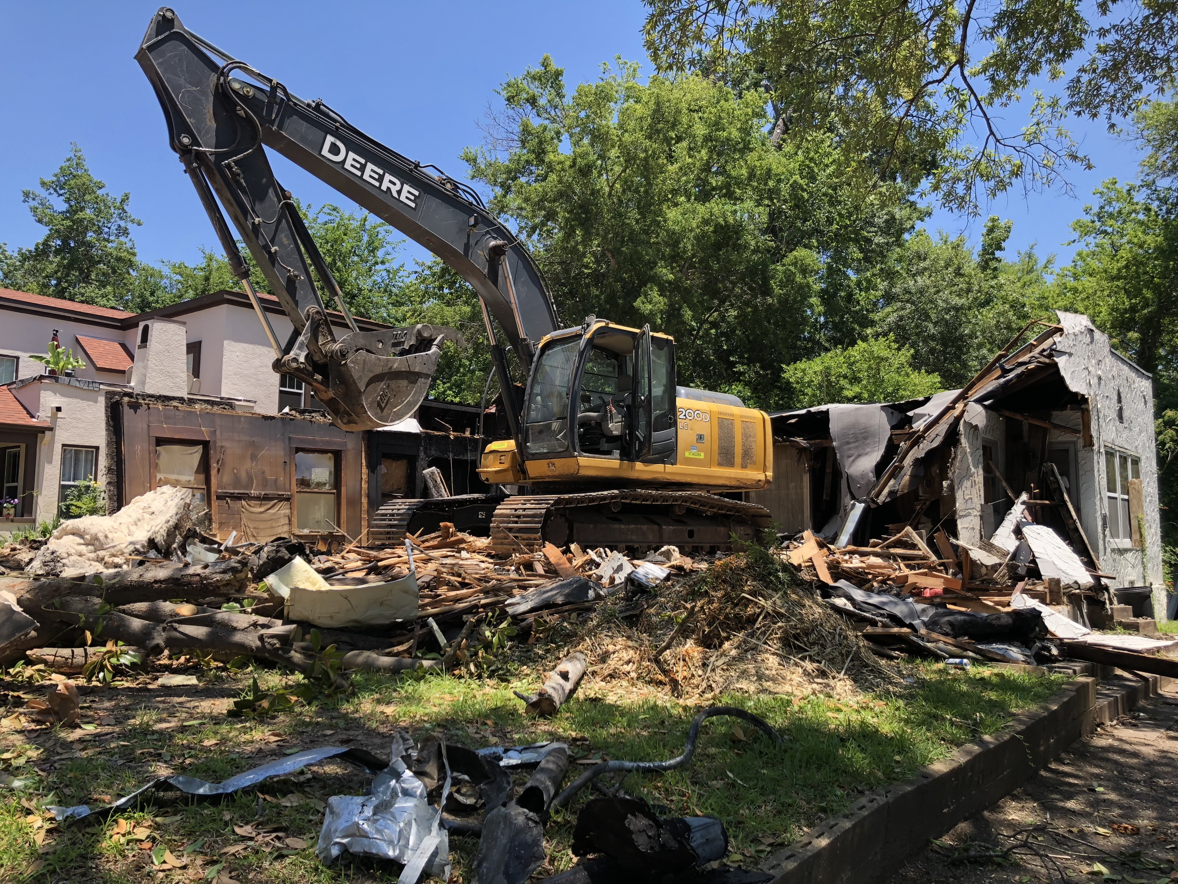 Excavator demolishing structure