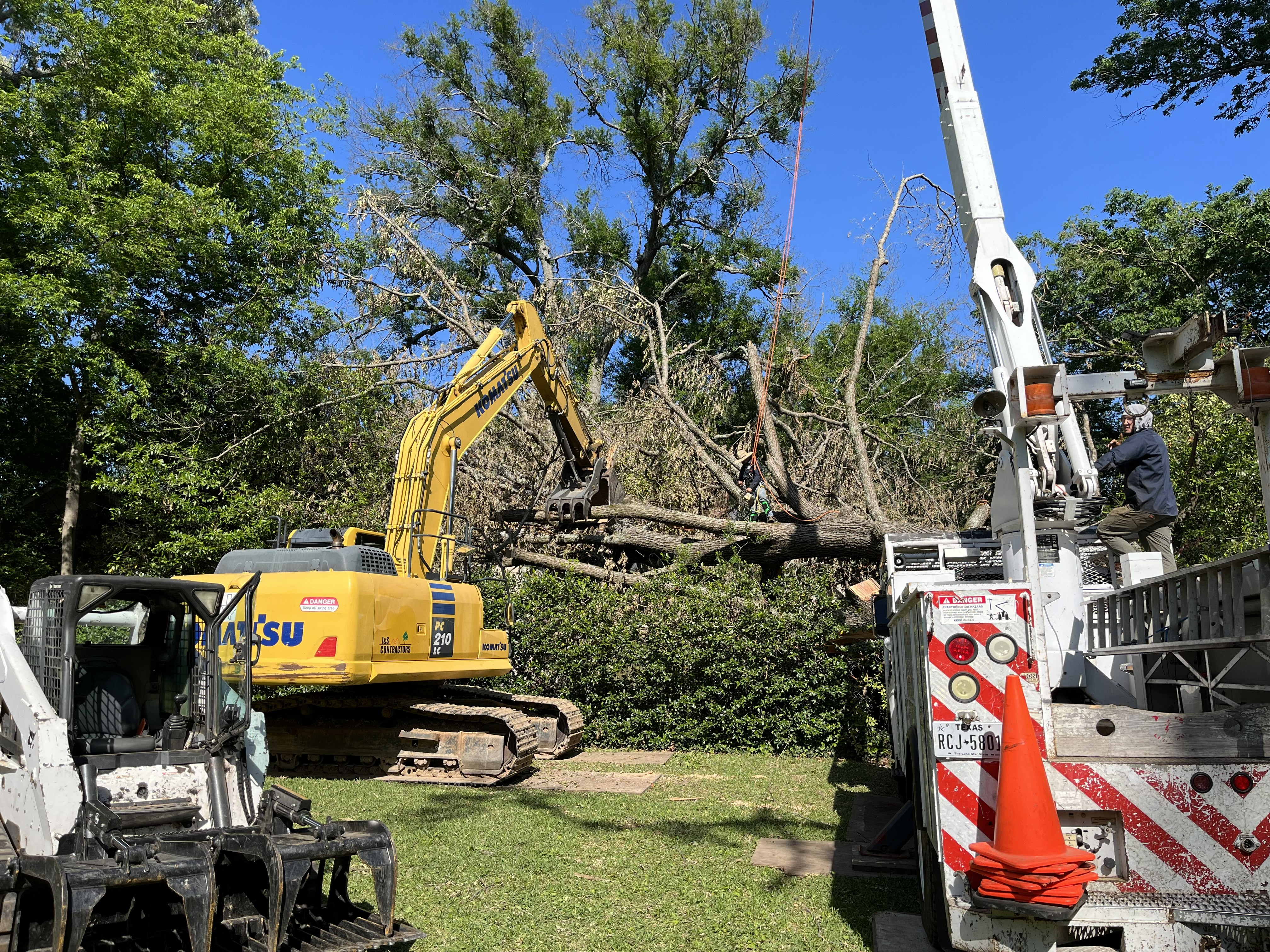 Excavator clearing trees and brush