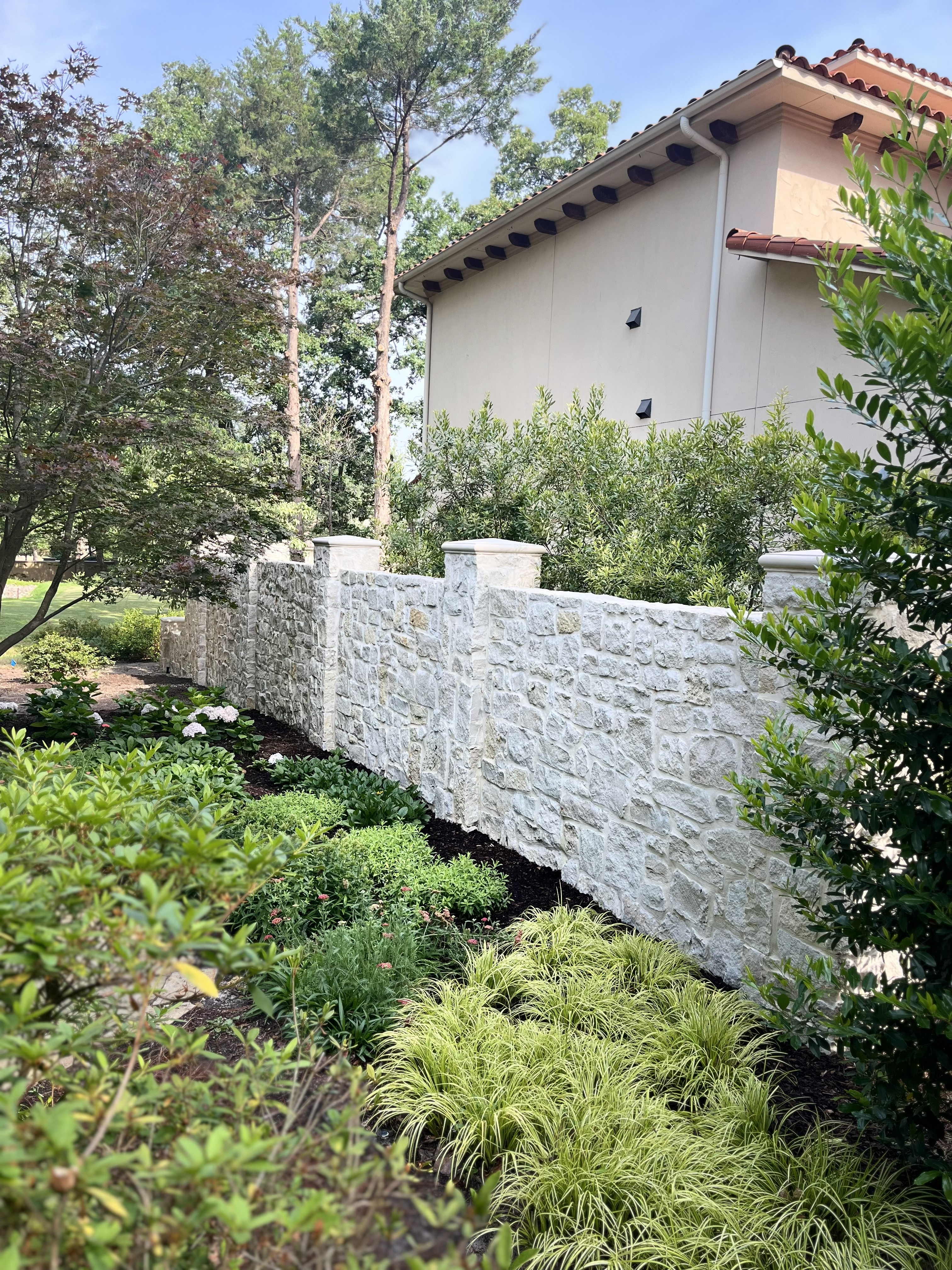 Stone retaining wall and fencing